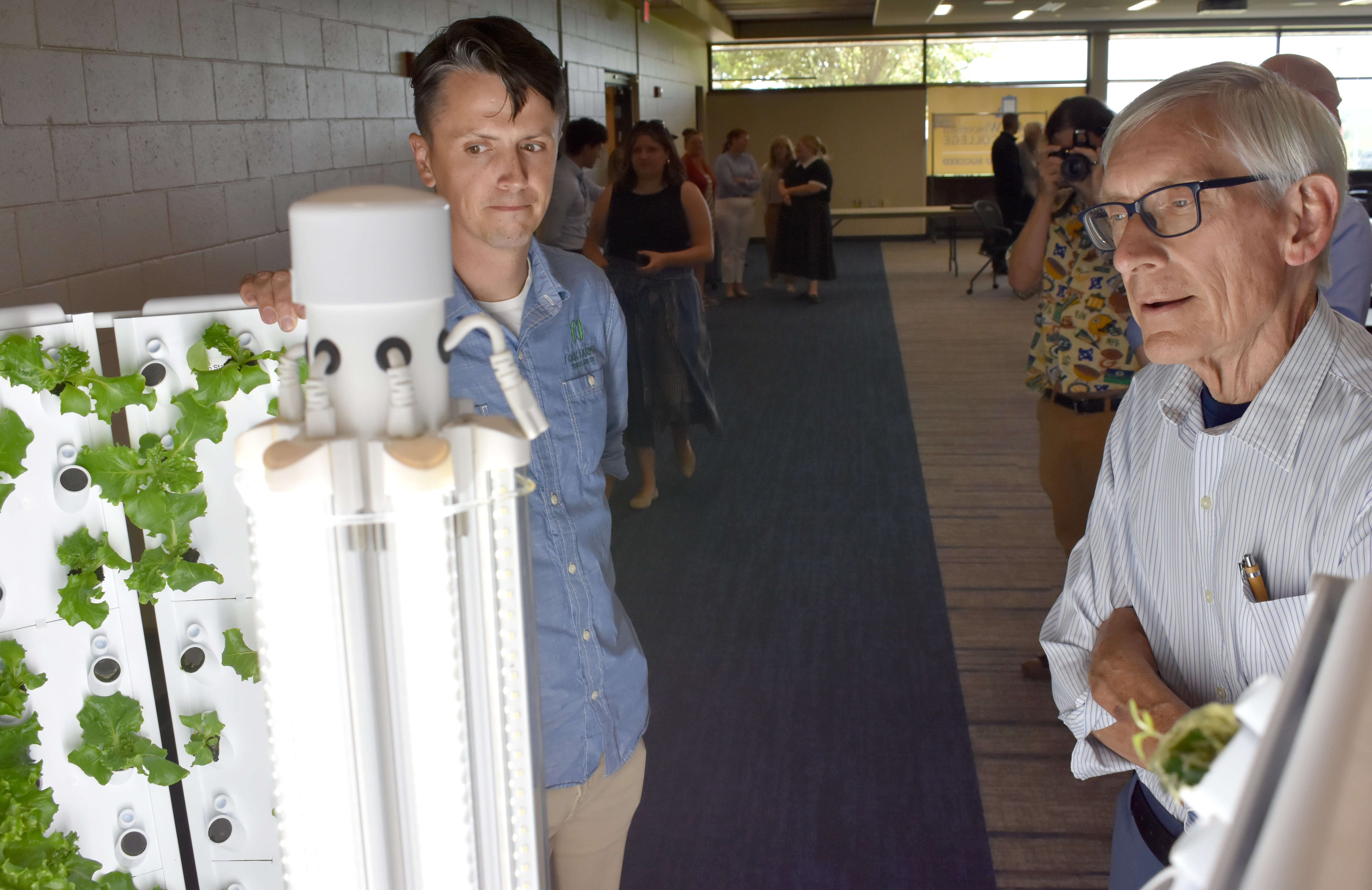 WI Gov. Tony Evers learns about the Flex Farm hydroponic unit from Josh Mahlik